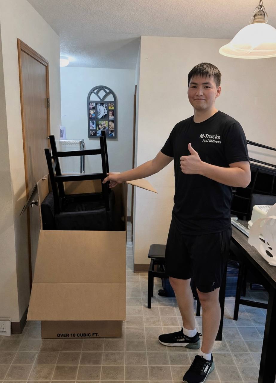 M-Trucks mover packing a chair into a moving box