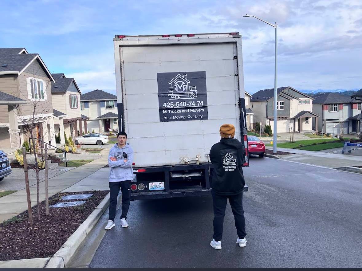 M-Trucks and Movers branded truck in Seattle neighborhood