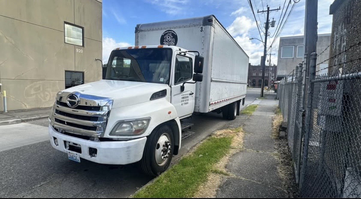 M-Trucks and Movers branded truck with company emblem